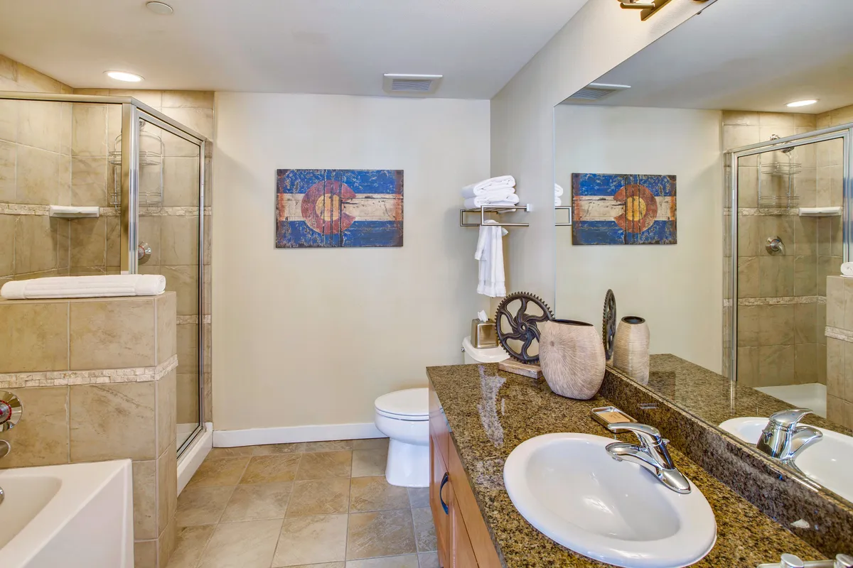 A modern bathroom featuring a double vanity sink, an inviting shower area, and tasteful decorative wall art. The space is bright, spacious, and exudes a spa-like ambiance.